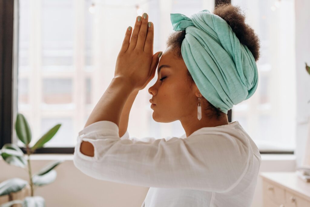 Woman practicing meditation indoors with a focus on relaxation and mindfulness.